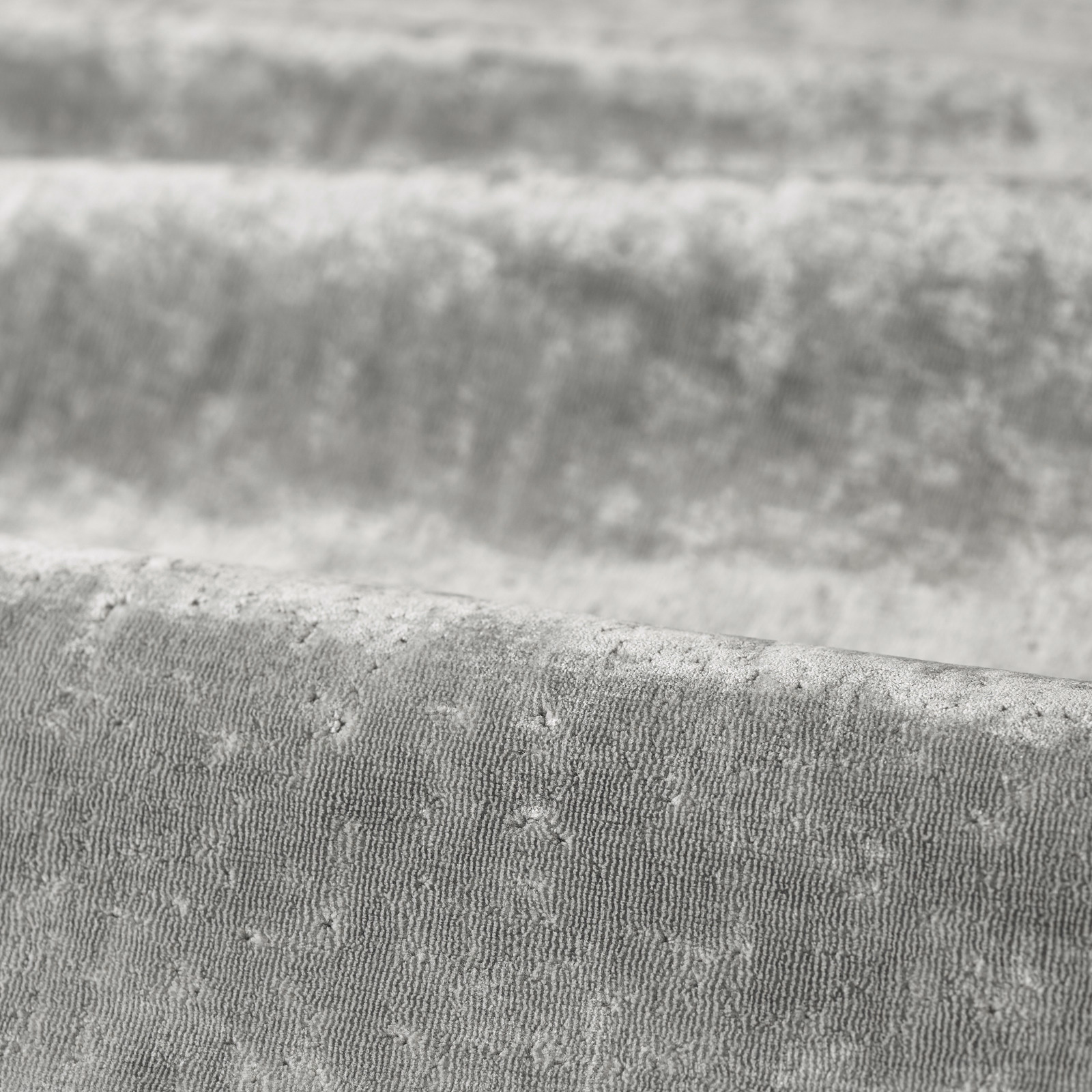 Cool silver-grey woven cloth with fine vertical ridging and softly raised flecks