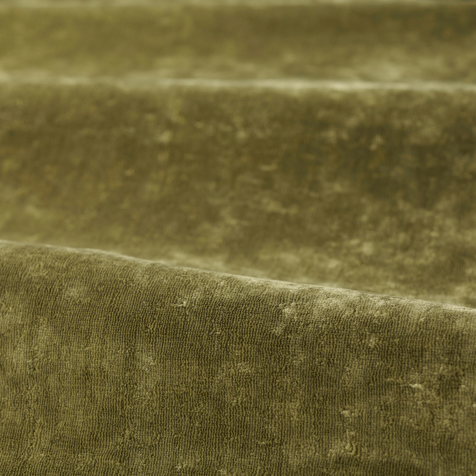 Close-up of Spanish olive green plush pile with subtle tonal mottling