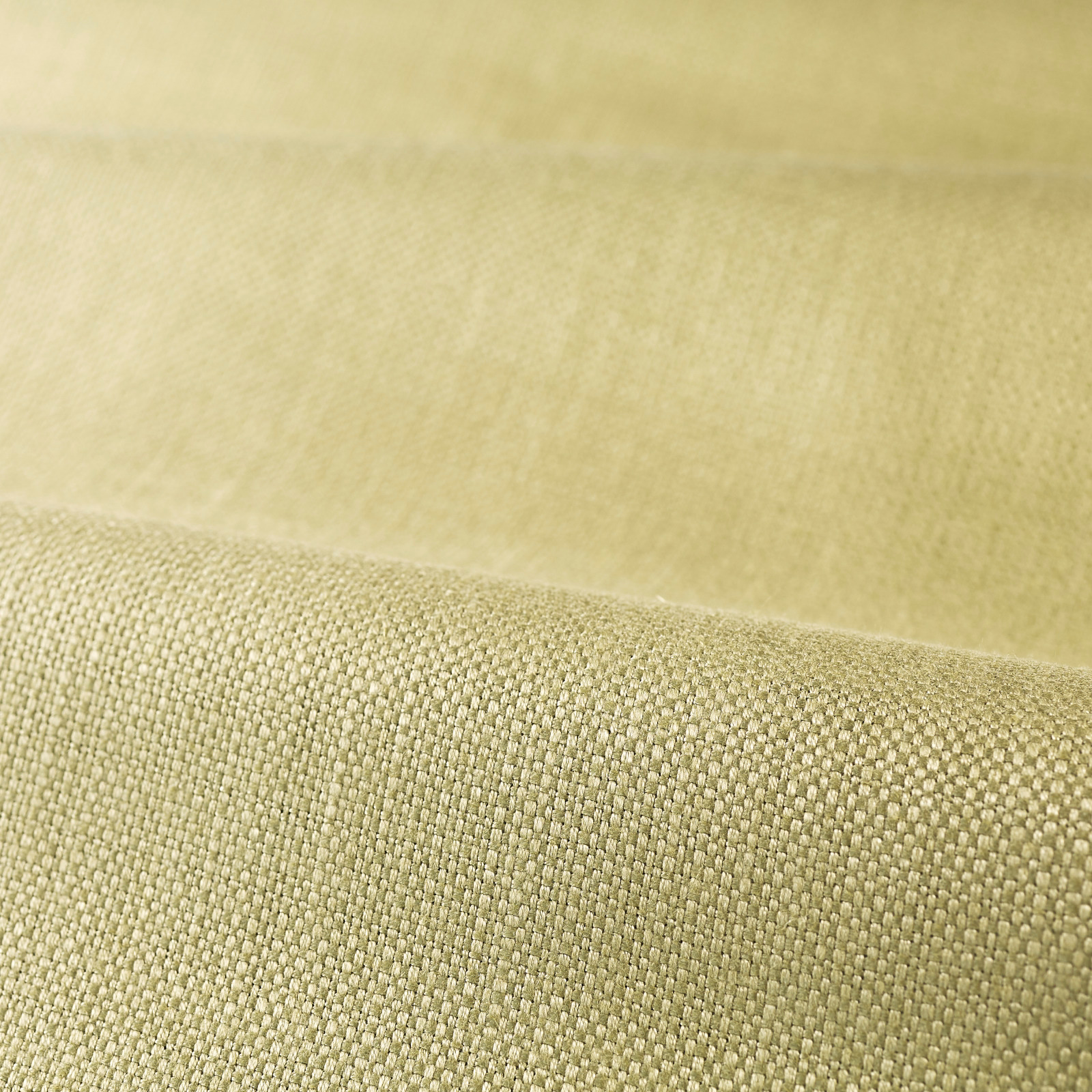 Close view of muted green tea fabric with a compact, softly textured plain weave