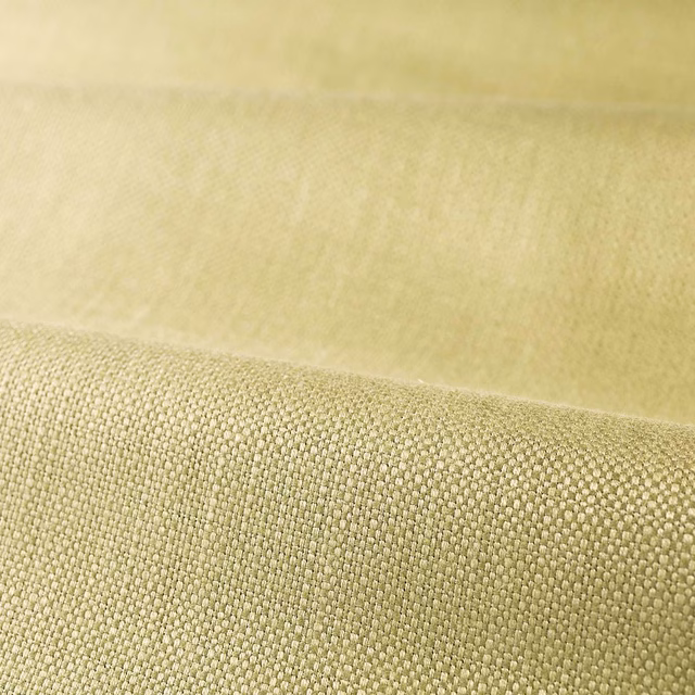 Close view of muted green tea fabric with a compact, softly textured plain weave