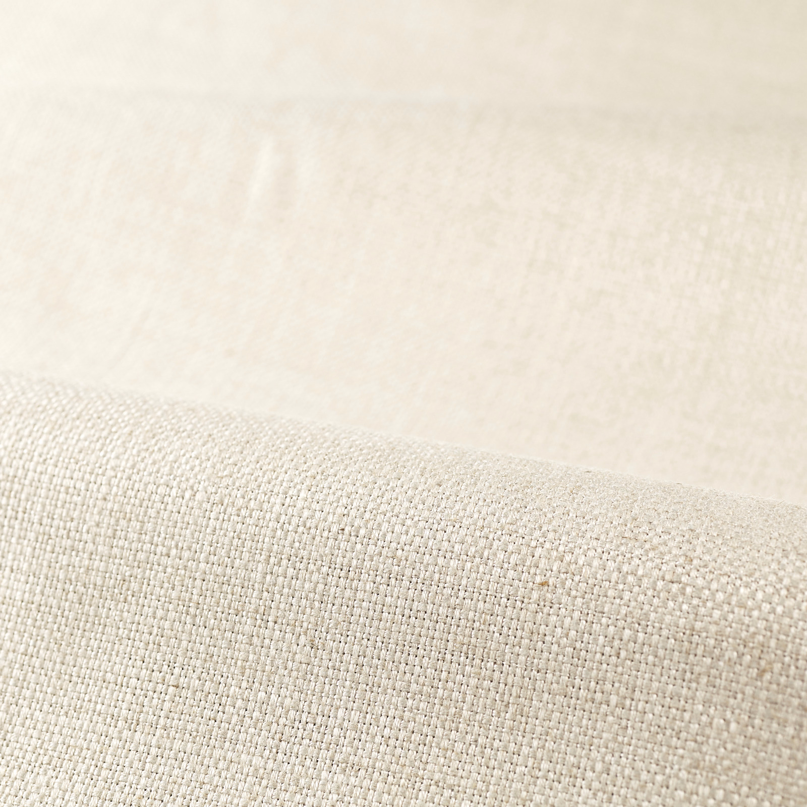 Pale undyed ivory fabric with a fine, softly irregular plain weave texture