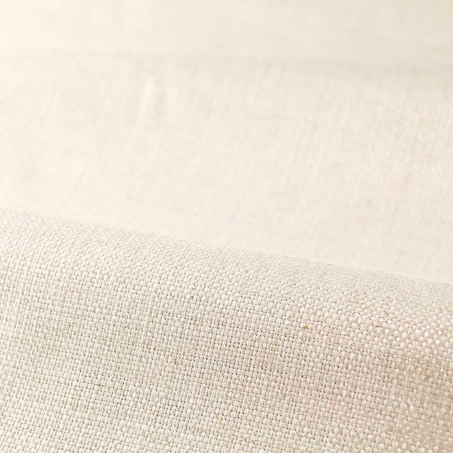 Pale undyed ivory fabric with a fine, softly irregular plain weave texture
