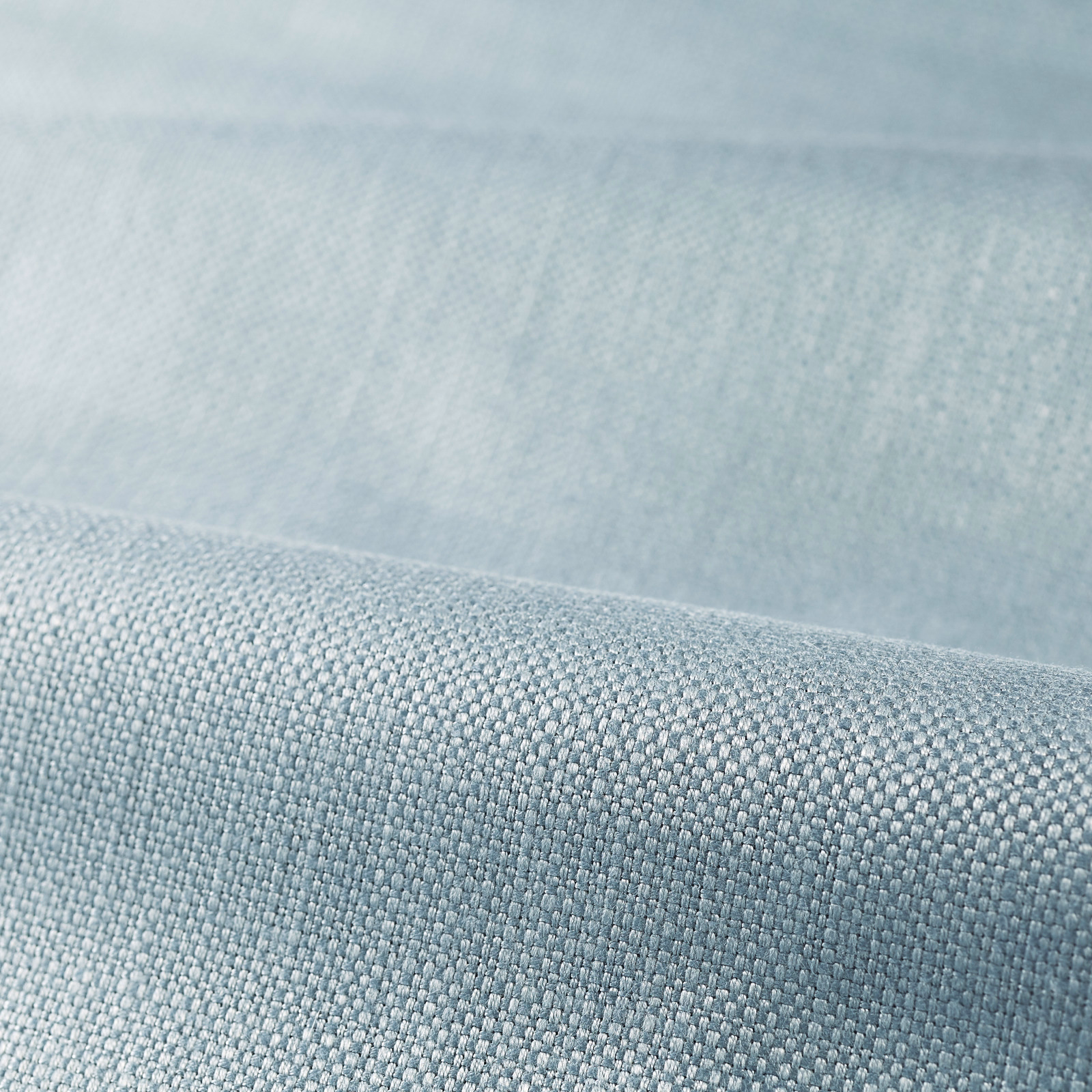 Close-up of pale Wedgwood blue fabric with a fine, softly textured plain weave