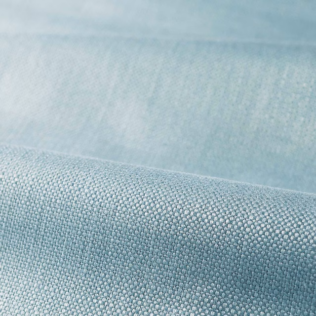 Close-up of pale Wedgwood blue fabric with a fine, softly textured plain weave