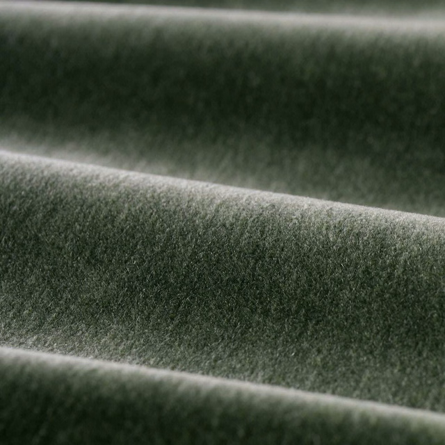 Deep moss-green velvet folds showing a dense plush pile and silvery highlights