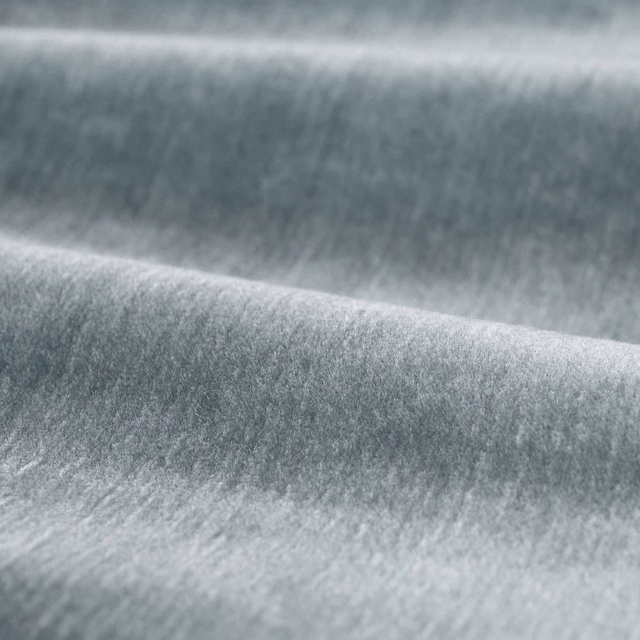 Cool silver-grey plain fabric with dense velvety pile and soft folded highlights