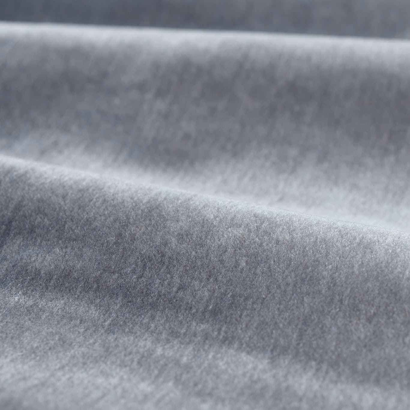 Cool silver-grey mohair pile with soft directional shading across folded fabric