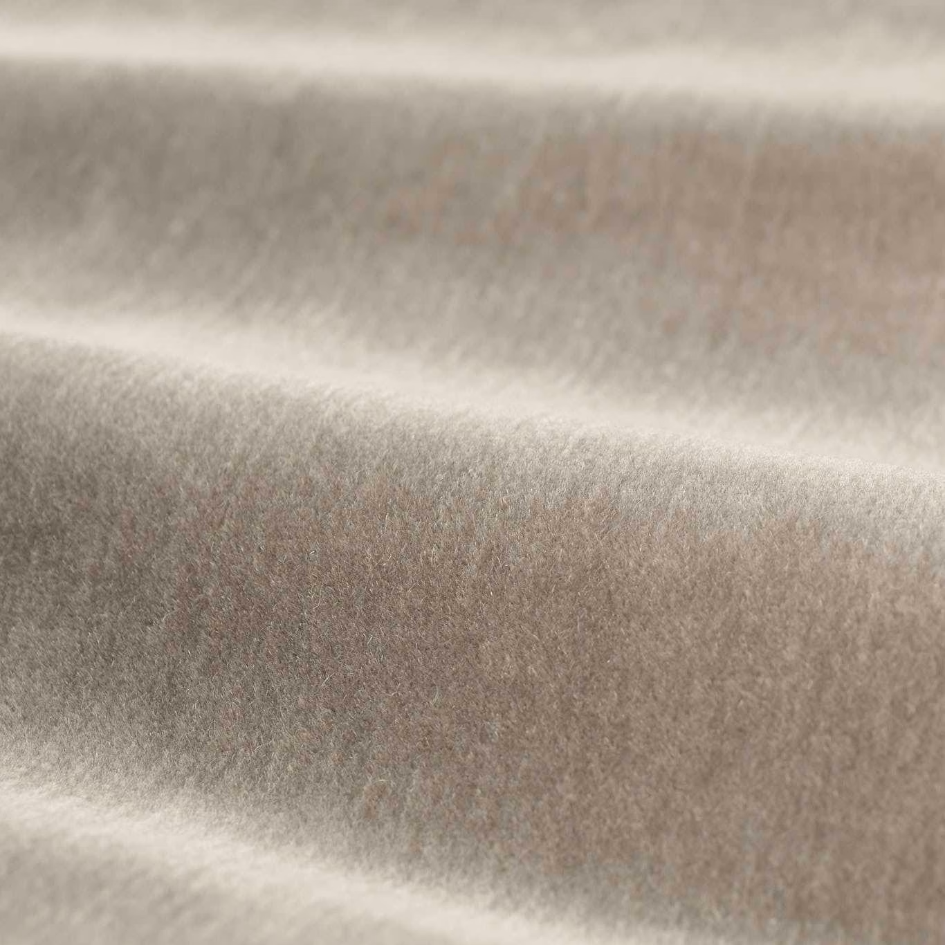 Smoky taupe-grey plush textile with soft directional sheen across folded velvet surface