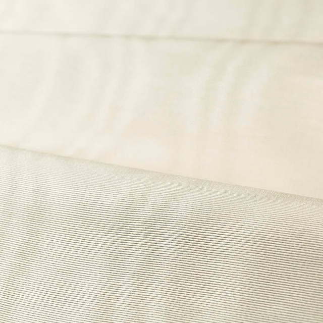 Pale chalk-ivory moiré fabric showing fine horizontal ribbing and softly shifting light