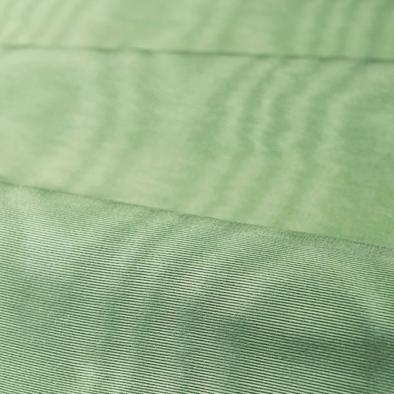Pale jade green moiré textile with cloudy ripples and a fine ribbed weave