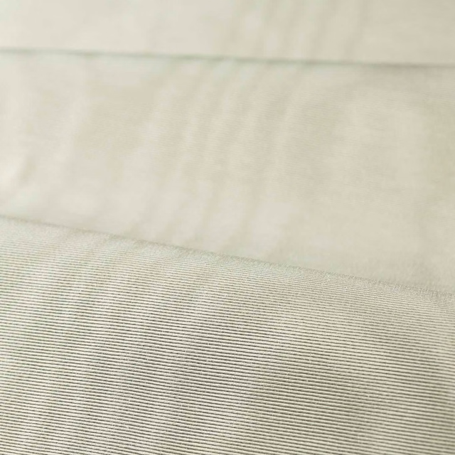 Pale platinum grey moiré fabric showing cloudy sheen and fine horizontal ribbing