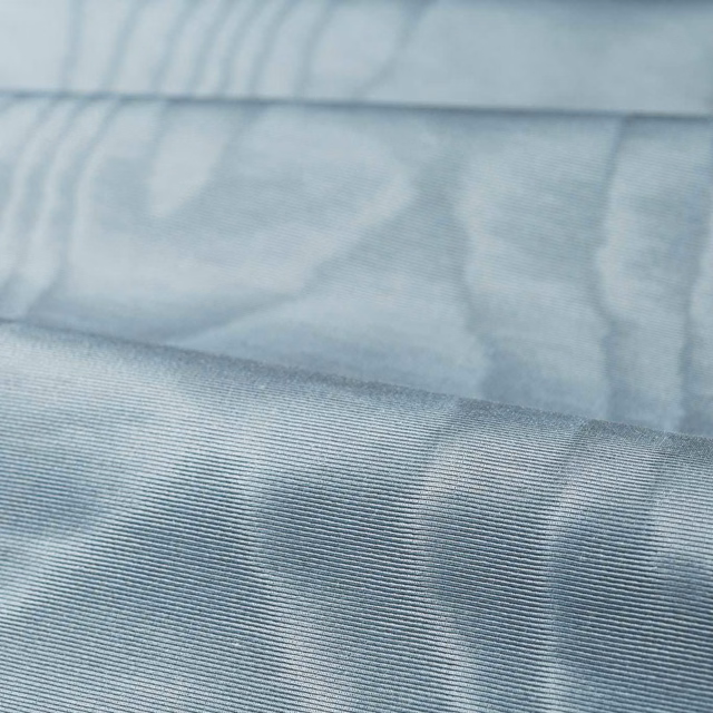 Pale icy blue-grey moiré fabric with fine horizontal ribbing and watery tonal bands
