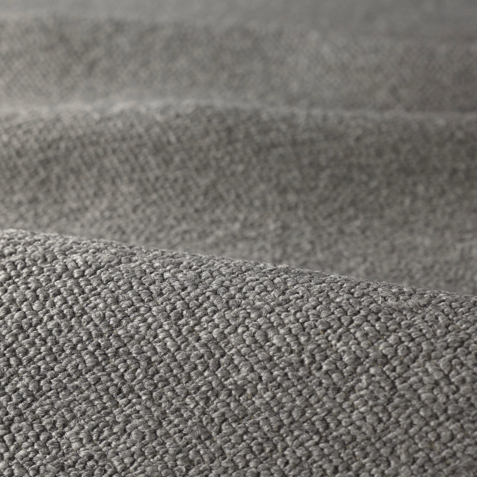 Close-up of cool grey bouclé fabric showing dense, raised looped texture