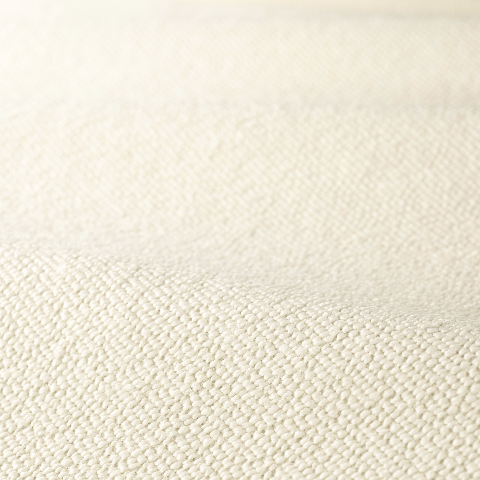 Warm creamy-white boucle upholstery with dense, softly irregular looped texture