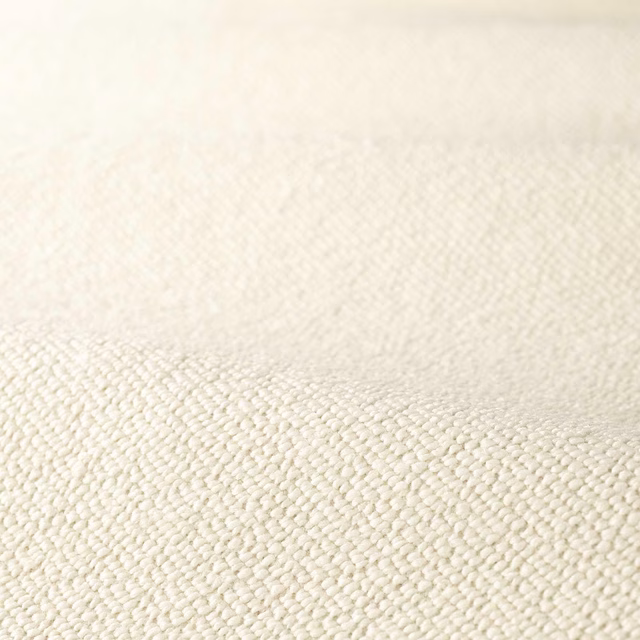 Warm creamy-white boucle upholstery with dense, softly irregular looped texture