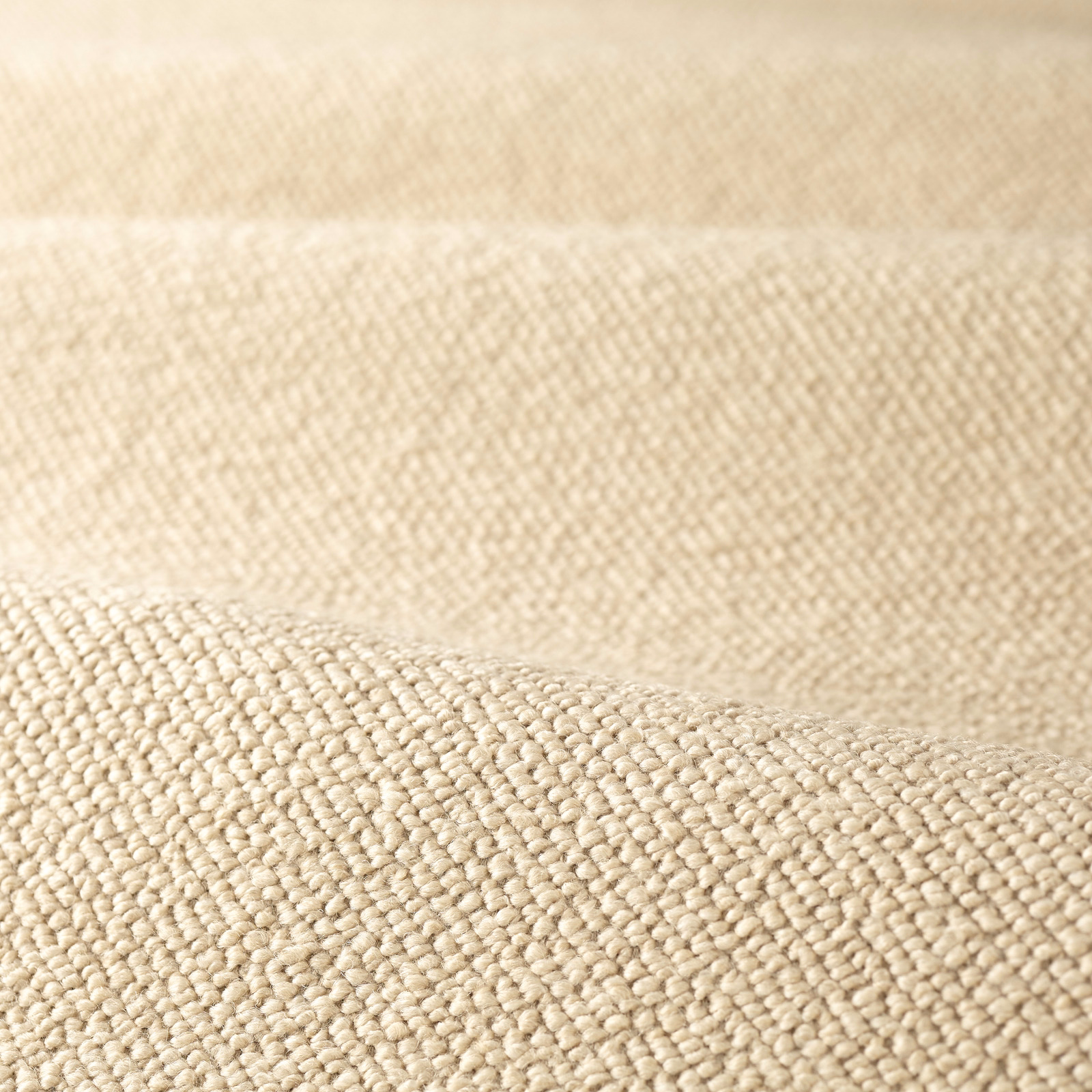 Warm stone beige boucle with dense rounded loops and softly shaded woven texture