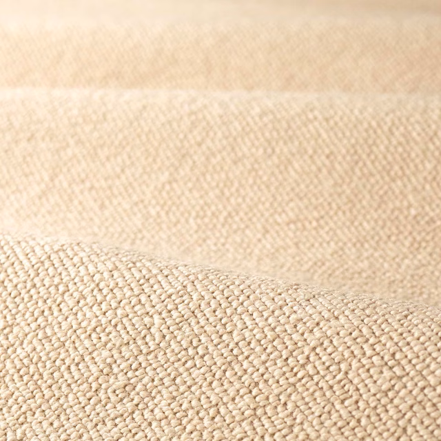 Warm stone beige boucle with dense rounded loops and softly shaded woven texture