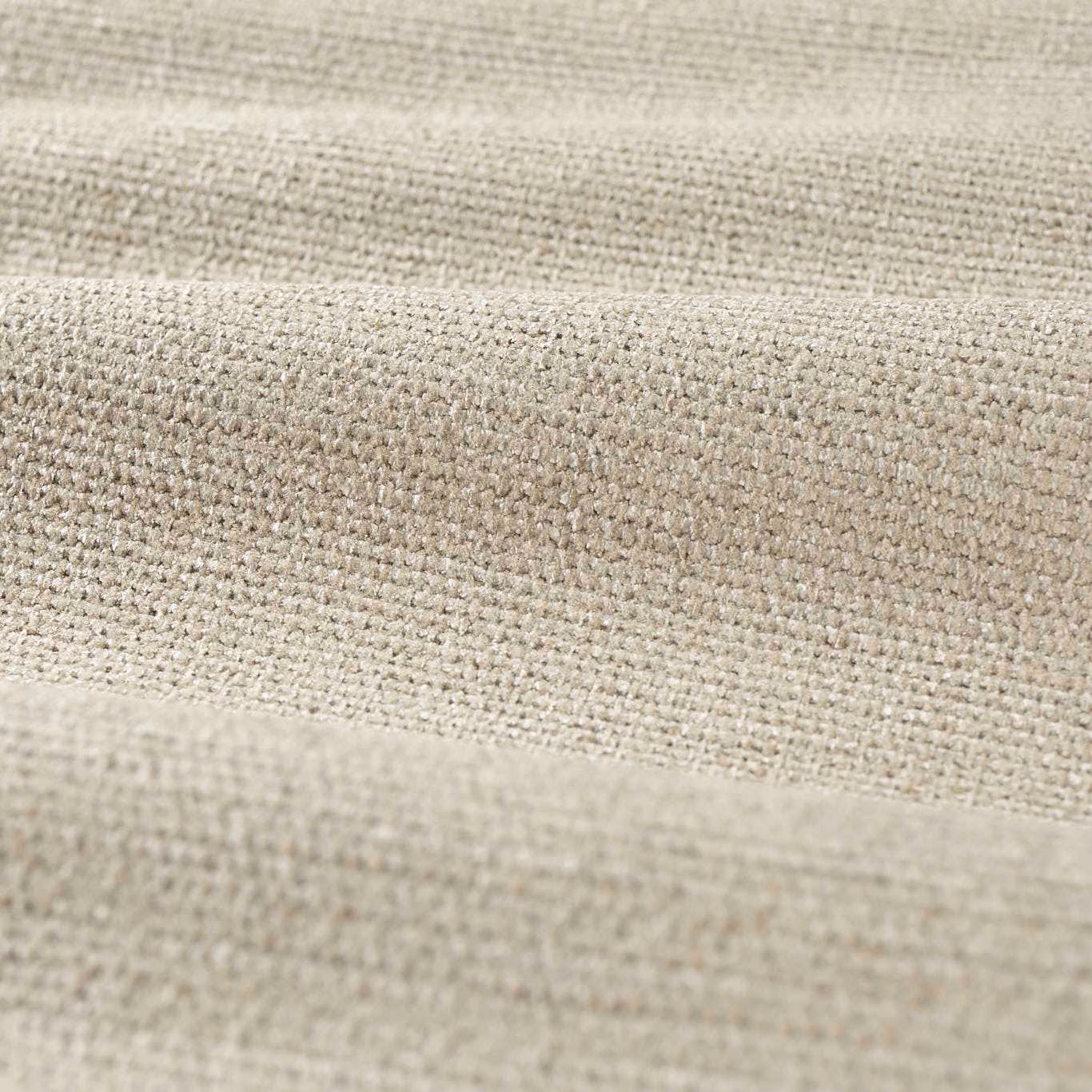 Close-up of pale warm beige chenille weave with fine flecks and soft horizontal folds