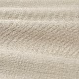 Close-up of pale warm beige chenille weave with fine flecks and soft horizontal folds
