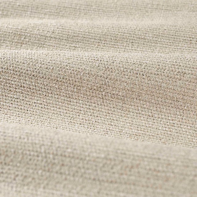 Close-up of pale warm beige chenille weave with fine flecks and soft horizontal folds