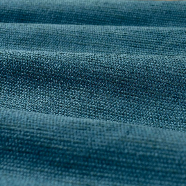Deep blue-teal chenille showing dense nubby weave across softly folded horizontal bands