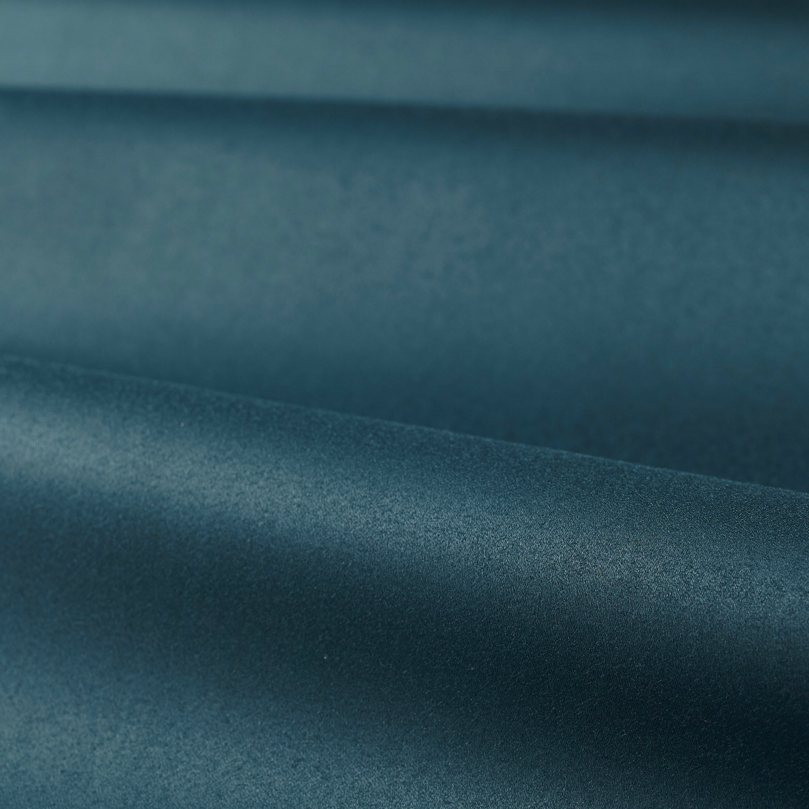 Deep Prussian blue satin weave with softly shifting highlights across folded cloth