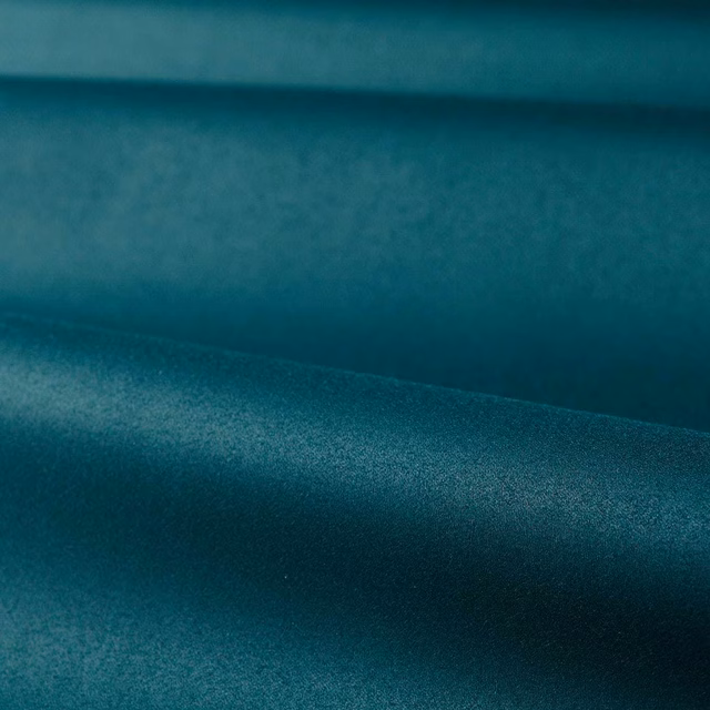 Deep Prussian blue satin weave with softly shifting highlights across folded cloth
