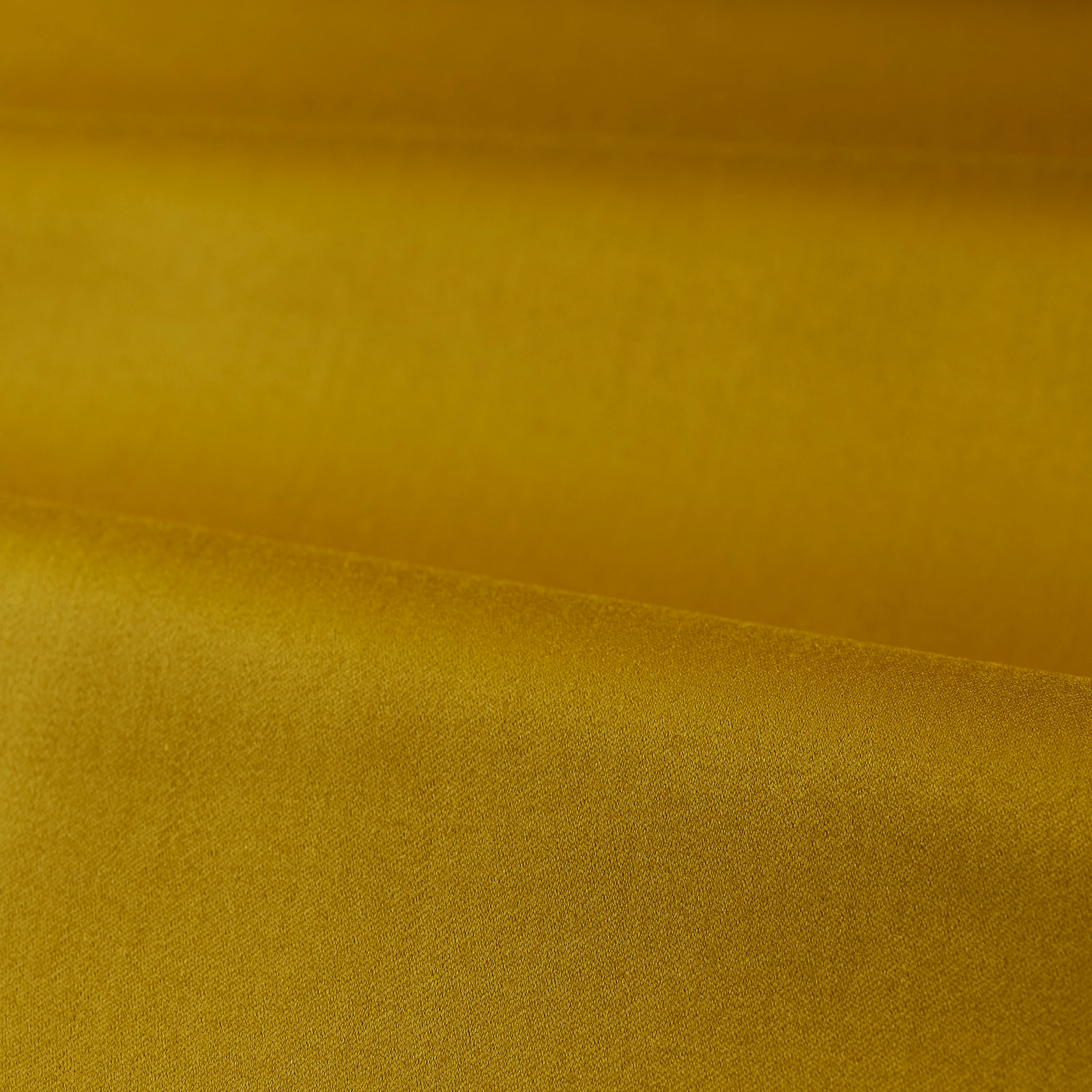 Mustard-gold satin fabric folded to show a fine, softly reflective weave
