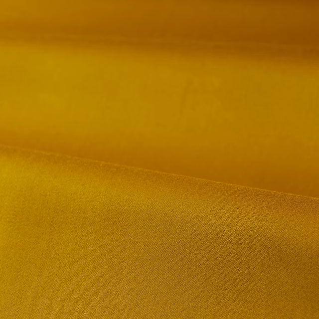 Mustard-gold satin fabric folded to show a fine, softly reflective weave