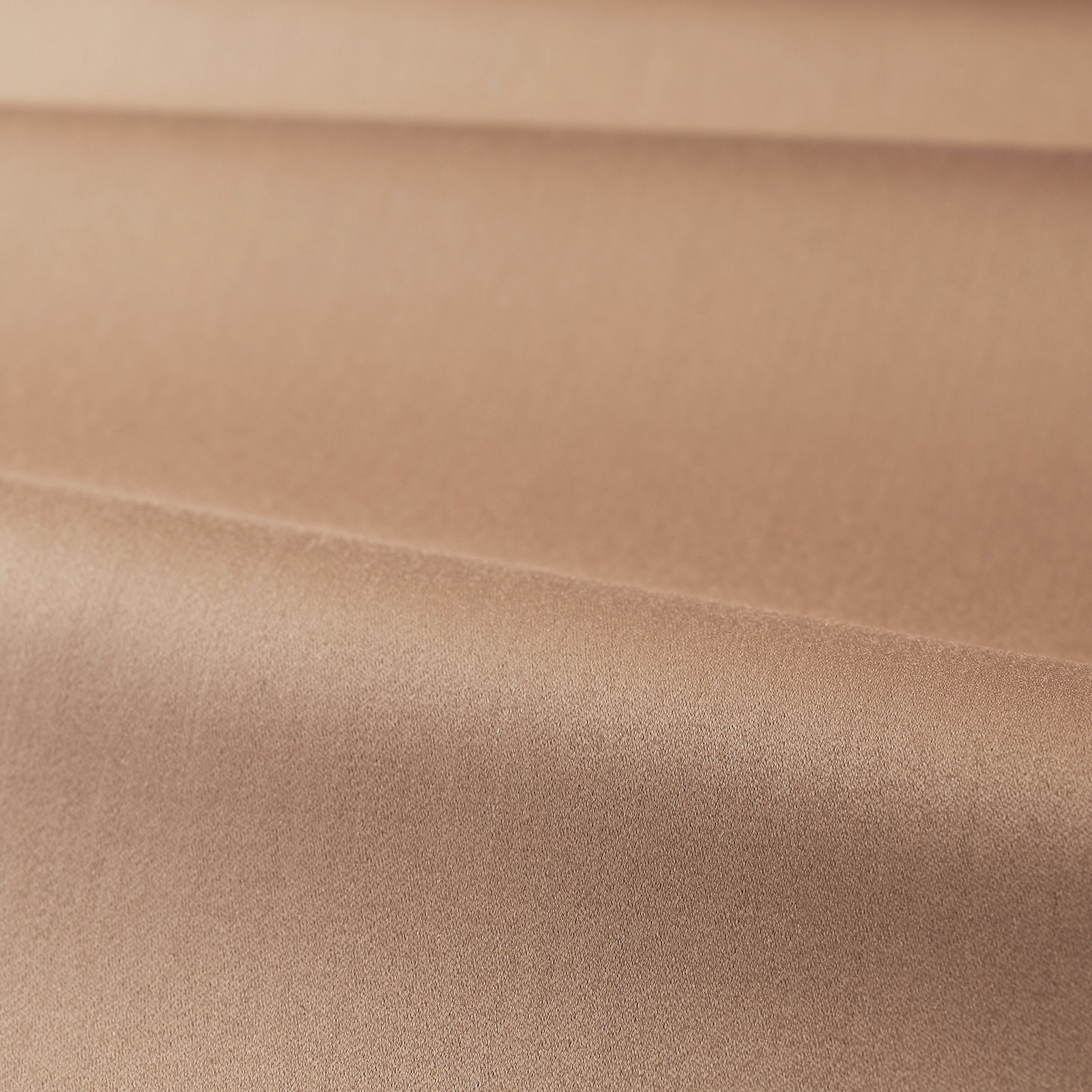 Close-up of smooth Tuscan pink satin with a soft horizontal fold and muted sheen