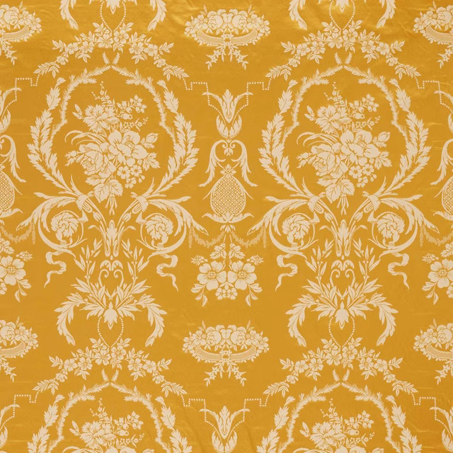 Warm ochre-gold damask with pale cream floral medallions and scrolling foliage