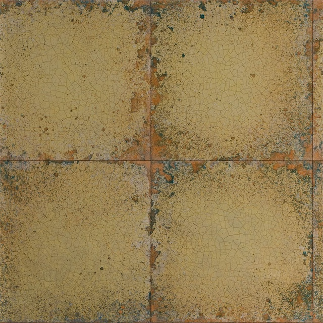 Aged ochre-gold tiled wallpaper with fine crackle lines and teal-rust patina