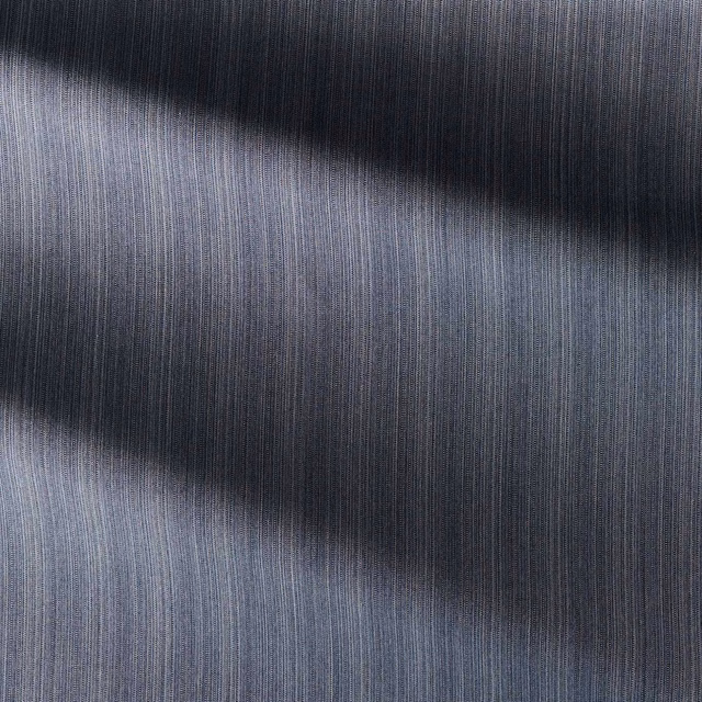 Deep indigo outdoor textile with fine vertical strié and smoky horizontal shading