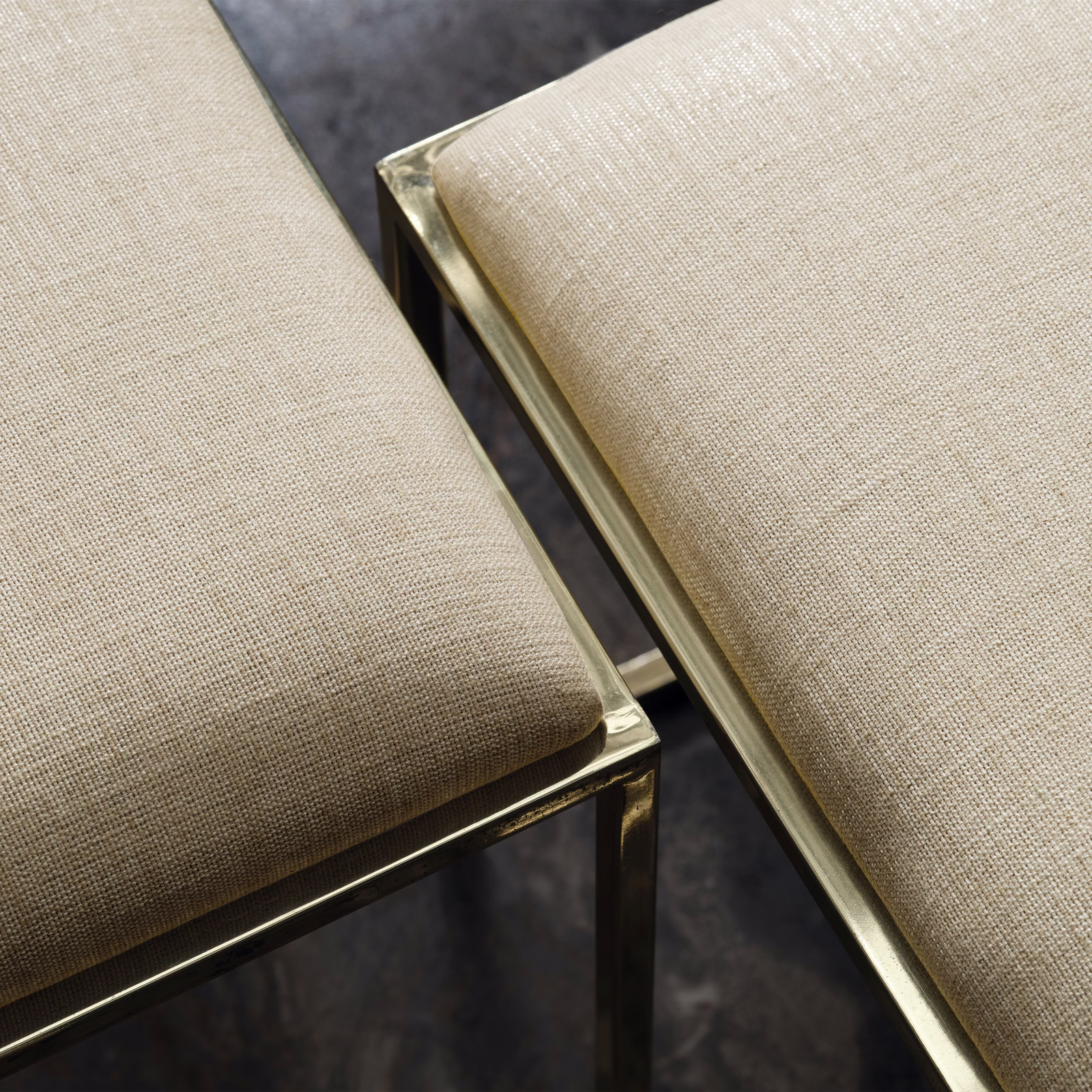 Warm greige fine-weave upholstery on two gold-framed chairs
