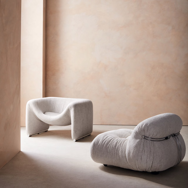 Warm pale greige textured upholstery covering rounded sculptural lounge chairs