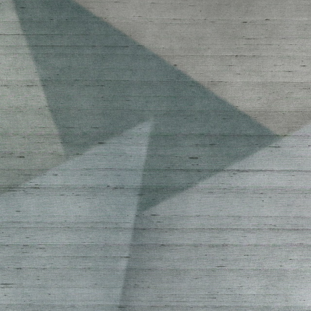 Muted verdigris wallpaper with large angular shadows and fine horizontal weathered striations