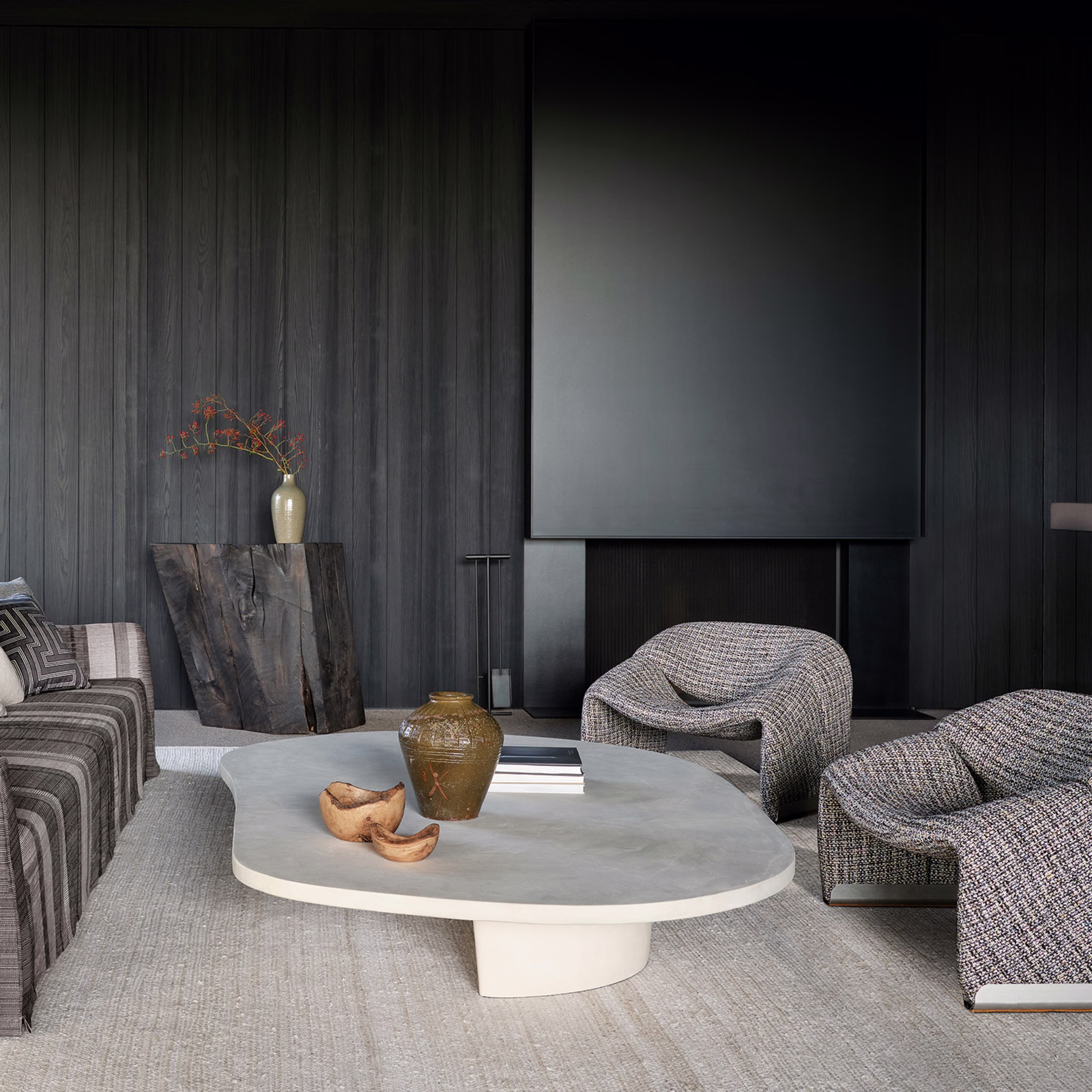 Warm greige textured upholstery on rounded lounge chairs beside a pale table