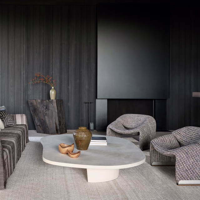 Warm greige textured upholstery on rounded lounge chairs beside a pale table