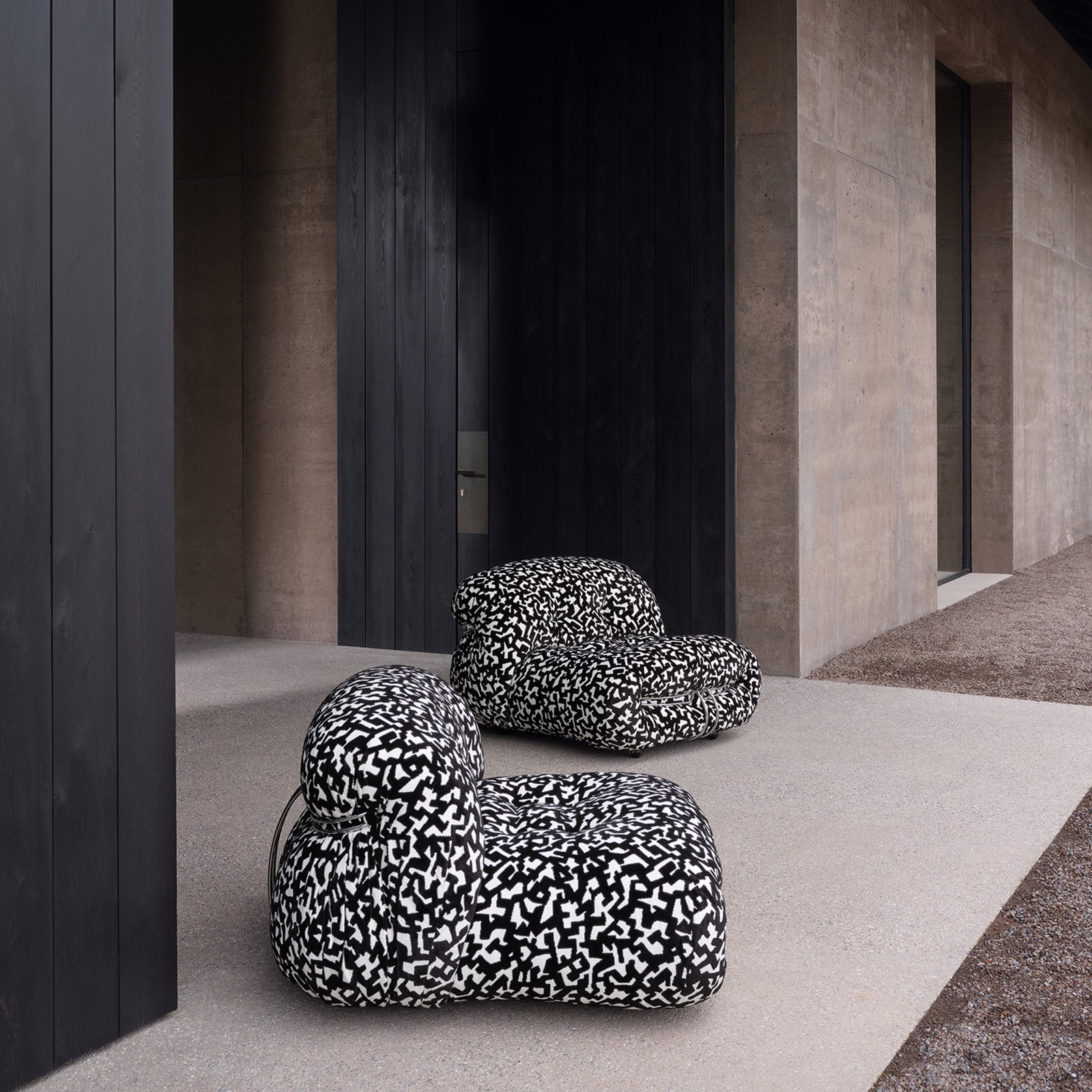 Black and white Dalmatian-patterned upholstery on rounded contemporary lounge chairs