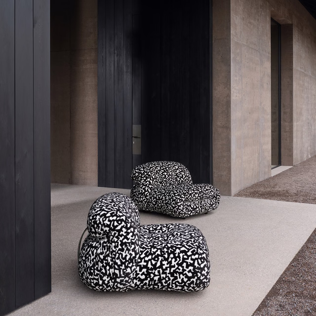 Black and white Dalmatian-patterned upholstery on rounded contemporary lounge chairs