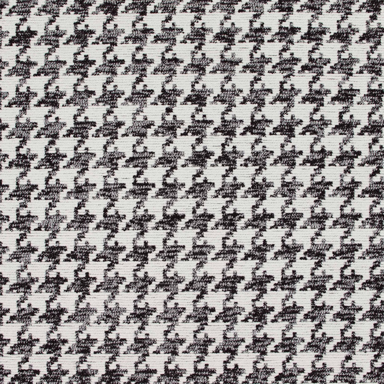 Close-up of ivory woven cloth with repeated black irregular dalmatian-like marks