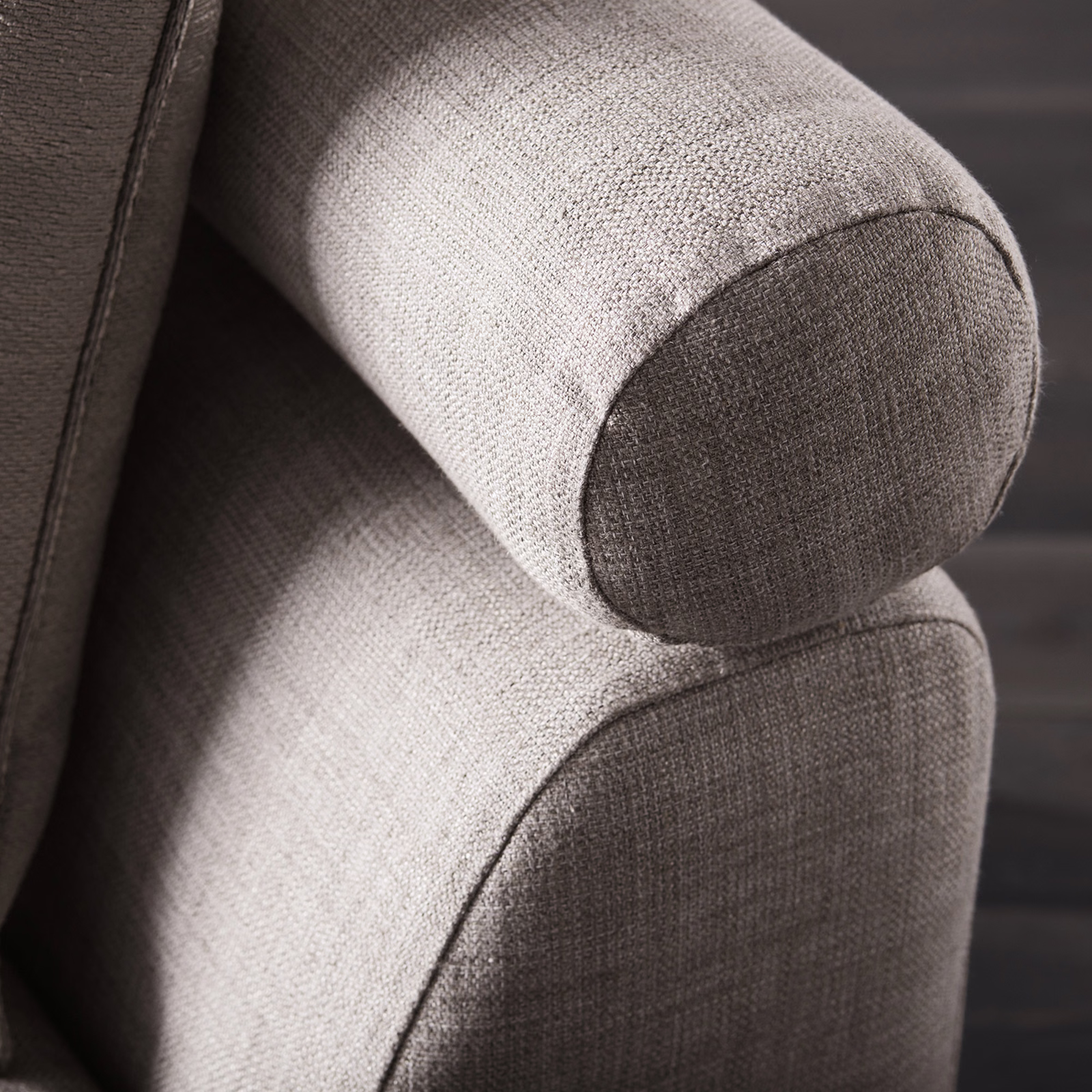 Cool silver-grey woven upholstery with darker graphite shading on a rounded armchair