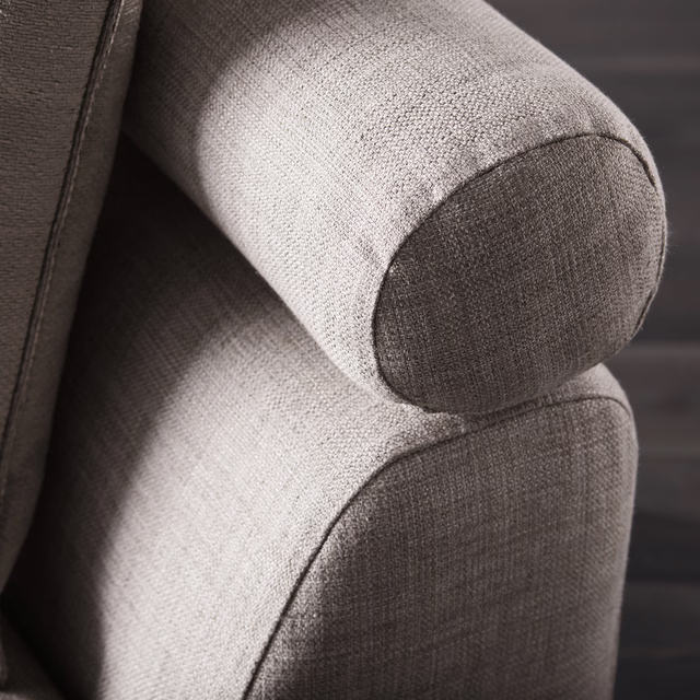 Cool silver-grey woven upholstery with darker graphite shading on a rounded armchair