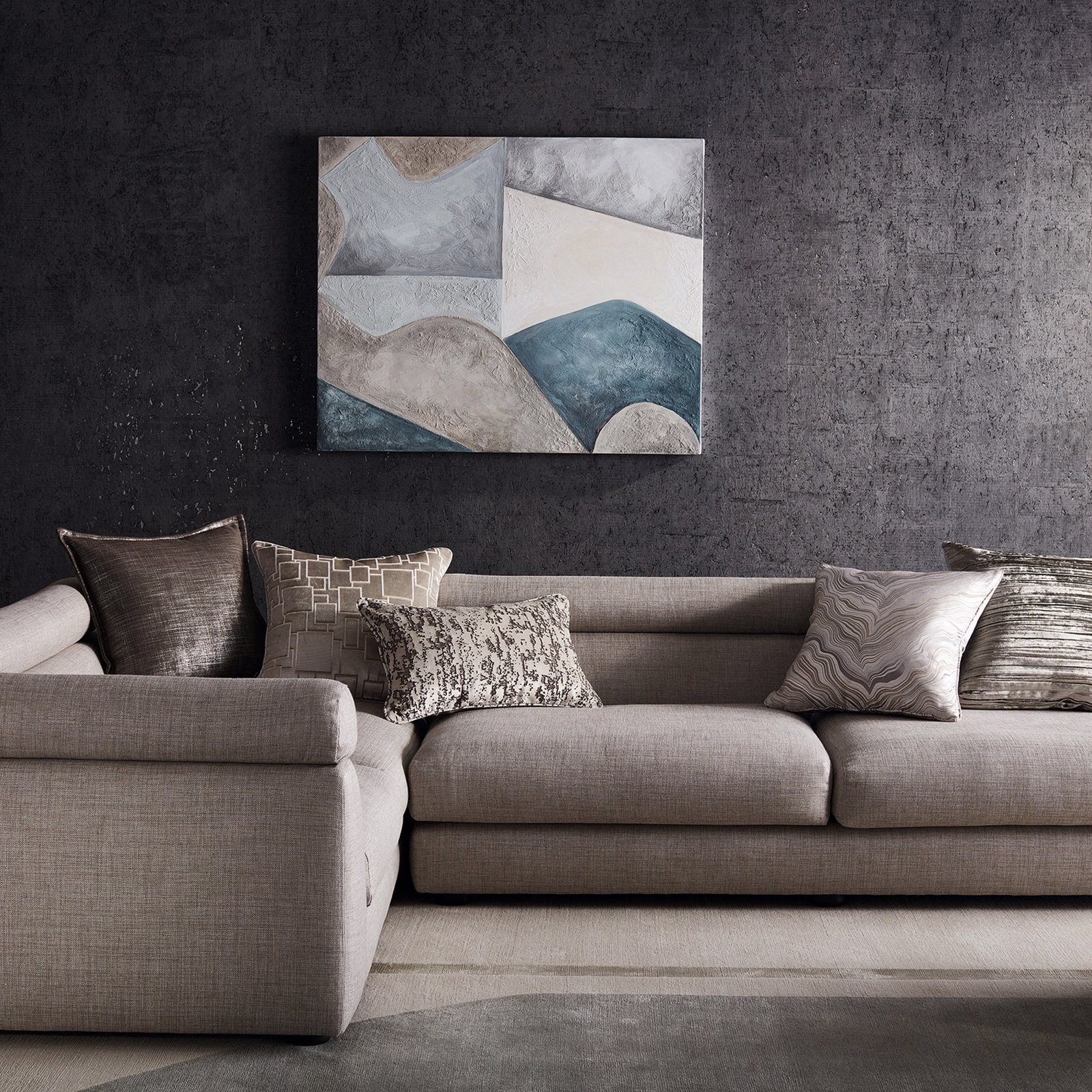 Warm stone-grey finely woven upholstery covering a deep contemporary sofa and chaise