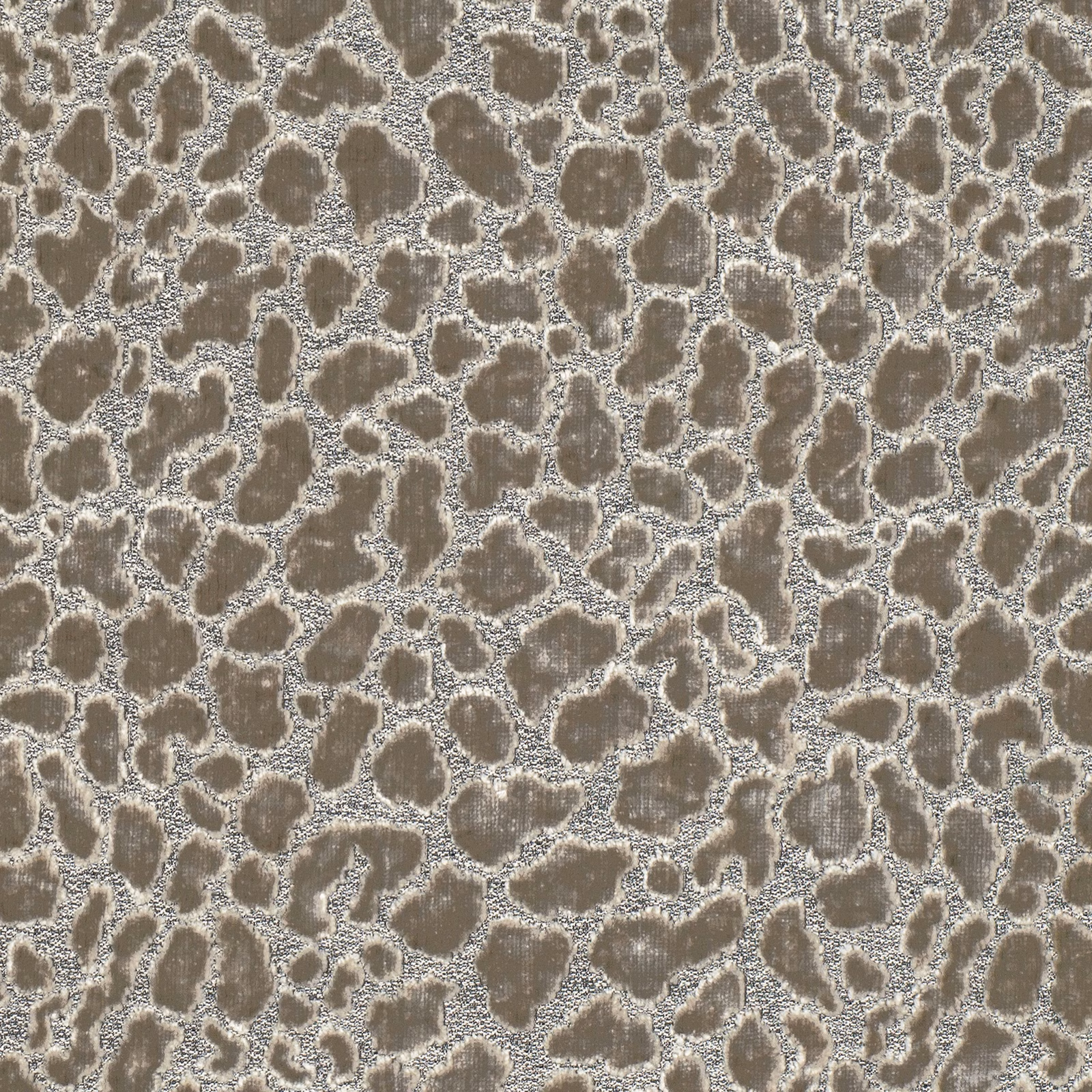 Taupe-grey ocelot spots with raised, nubby woven texture on a pale ground