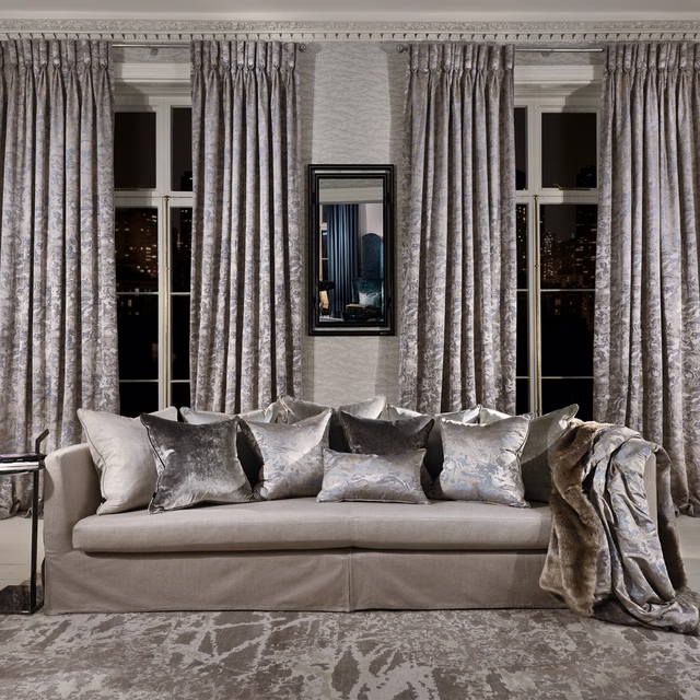 Full-length cool silver-grey curtains in a pleated, softly mottled organic fabric