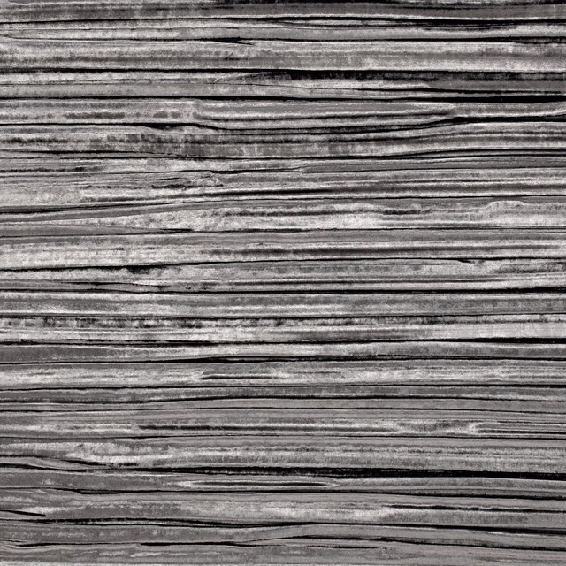 Charcoal and silver-grey fabric with dense horizontal striations and smoky texture
