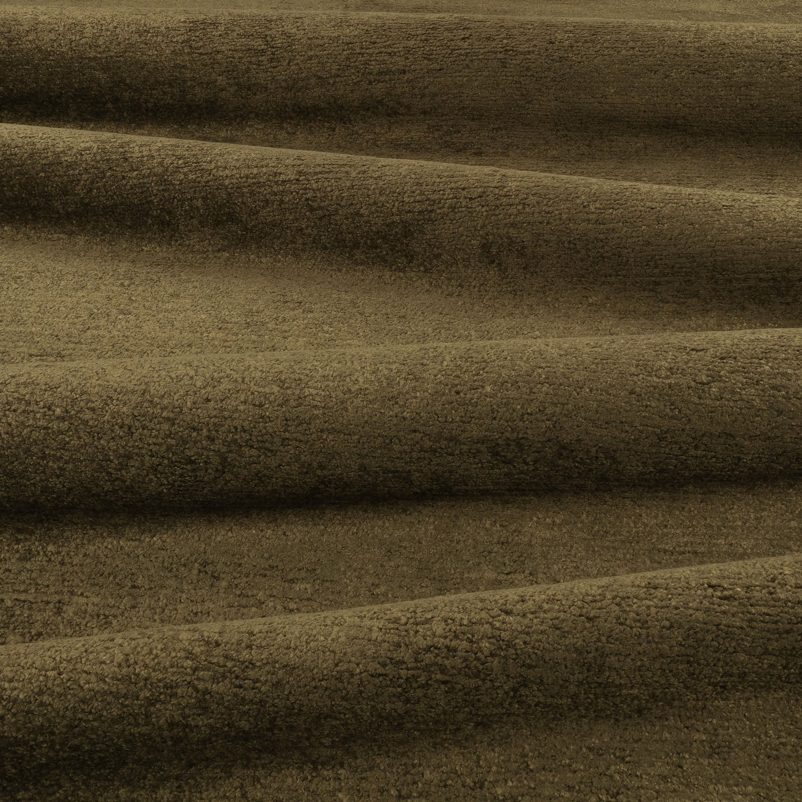 Muted tarragon olive plush textile with dark horizontal folds and mottled pile