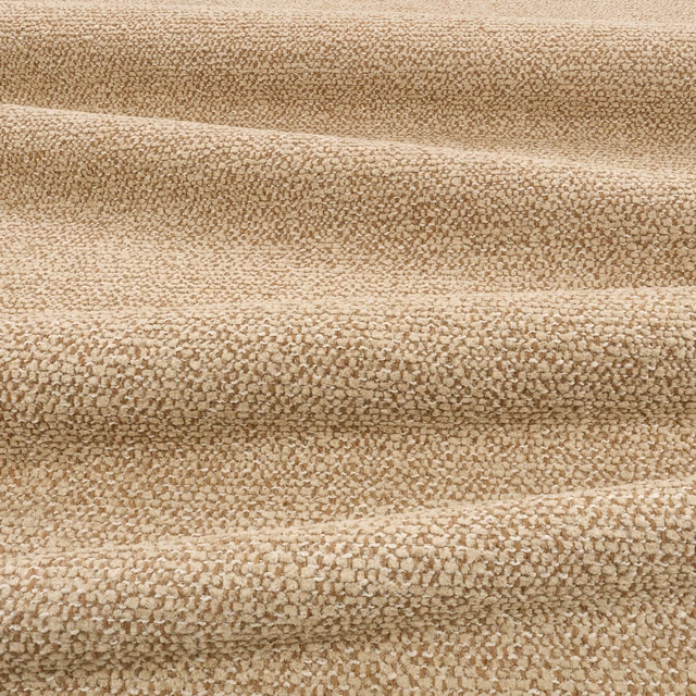 Warm camel-beige nubby textile with cream flecks and softly folded ridges