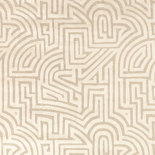 Warm ivory textile with taupe maze-like geometric lines and visible woven grain